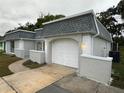 White, attached one-car garage with paved driveway at 3349 Overland Dr, Holiday, FL 34691