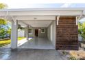 Carport with a wooden accent wall and a view of the front door at 341 Bahia Vista Dr, Indian Rocks Beach, FL 33785