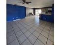 Open-concept living area with tiled floors, blue walls, and a view of the kitchen at 3854 12Th S Ave, St Petersburg, FL 33711