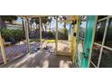 Bright screened porch with brick patio and view of backyard at 504 79Th Ave, St Pete Beach, FL 33706