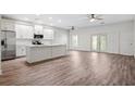 Bright, open-concept kitchen with stainless steel appliances and an island, flowing into a spacious living area at 6454 Freeport Dr, Spring Hill, FL 34608