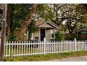 Charming home with a white picket fence and lush landscaping at 8303 N Mulberry St, Tampa, FL 33604