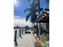 Private dock with a wooden pergola, palm trees, and stunning water views at 8384 Antwerp Cir, Port Charlotte, FL 33981
