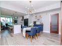 Dining area with a round table, blue chairs, and a bar area at 912 Channelside Dr # 2412, Tampa, FL 33602