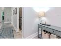 Hallway with a console table, laundry closet, and patterned rug at 912 Channelside Dr # 2412, Tampa, FL 33602