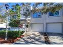 Two-story townhome with attached garage and manicured landscaping at 9487 Tara Cay Ct, Seminole, FL 33776