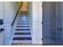 Interior staircase with tile accents and dark wood at 9487 Tara Cay Ct, Seminole, FL 33776