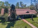 Beautiful aerial view of a single story home featuring a long driveway and mature trees at 1055 Riverside Ridge Rd, Tarpon Springs, FL 34688