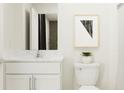 Bright, clean bathroom with white vanity, marble countertop, and modern fixtures at 15129 Rainbow Quartz St, Wimauma, FL 33598