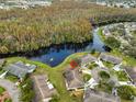 An aerial view showcasing the home's location near water and surrounding properties at 2003 Halmrock Pl, Sun City Center, FL 33573
