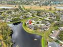 Aerial view of the home nestled in a community with a pond at 2003 Halmrock Pl, Sun City Center, FL 33573