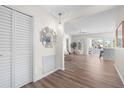 Bright foyer leading to an open-concept living area with stylish decor and wood-look flooring at 5101 Huntington Ne Cir, St Petersburg, FL 33703
