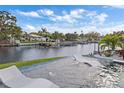 Relaxing pool with in-water loungers, overlooking a picturesque canal and boat docks at 5101 Huntington Ne Cir, St Petersburg, FL 33703