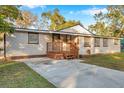 Inviting single-story home with a wooden porch and a paved driveway at 7206 E 29Th Ave, Tampa, FL 33619