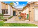 Front entry of home with walkway, landscaping, and decorative pot at 7497 Heather Walk Dr, Weeki Wachee, FL 34613