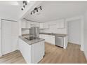Modern kitchen with white cabinets, stainless steel appliances, and granite countertops at 1708 E Poinsettia Ave, Tampa, FL 33612