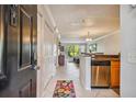 Entryway with tile floor, a colorful rug, and view into the kitchen at 2400 Feather Sound Dr # 515, Clearwater, FL 33762