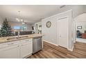 Open kitchen with white cabinets, granite countertops, and stainless steel appliances at 6937 Exeter Park Pl, Apollo Beach, FL 33572