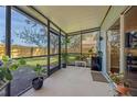 Covered screened porch with plants, perfect for relaxing or entertaining at 6937 Exeter Park Pl, Apollo Beach, FL 33572