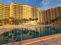 Building exterior with pool and palm trees at 880 Mandalay Ave # C314, Clearwater Beach, FL 33767