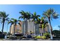 Beachfront building exterior with palm trees at 880 Mandalay Ave # C314, Clearwater Beach, FL 33767