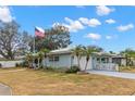 Light blue home with a two-car garage and manicured lawn at 1816 Woodridge Dr, Clearwater, FL 33756