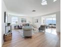 Open concept living area with hardwood floors and sunlit windows at 2460 Terry Ln, Sarasota, FL 34231