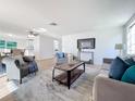 Bright and airy living room featuring hardwood floors and comfy seating at 2460 Terry Ln, Sarasota, FL 34231