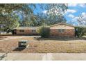 Brick ranch house with carport and mature landscaping at 3700 Dana Shores Dr, Tampa, FL 33634