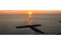 Scenic ocean view at sunset with a boat sailing by at 7000 Beach Plz # 706, St Pete Beach, FL 33706