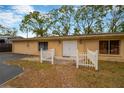 Front view of a single-story home with a white picket fence at 703 W Sligh Ave, Tampa, FL 33604