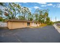 Paved driveway and white picket fence leading to a single-story home at 703 W Sligh Ave, Tampa, FL 33604