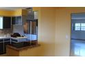 Kitchen with dark cabinets, light countertops, and black appliances at 7116 Kingsbury Cir, Tampa, FL 33610