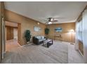 Bright and airy living room with tiled floors, a ceiling fan, and comfortable seating at 7471 35Th N St, Pinellas Park, FL 33781