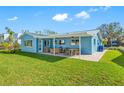 Newly renovated home with a spacious backyard, covered patio, and sitting area at 819 59Th Ave, St Pete Beach, FL 33706