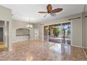 Open living room with tile flooring, a ceiling fan, and a sliding door to the screened-in lanai at 1160 Darlington Oak Ne Dr, St Petersburg, FL 33703