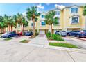 Yellow townhouses with palm trees and parking at 150 Brent Cir, Oldsmar, FL 34677