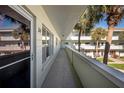 Exterior of a light green two-story building with palm trees and ample parking at 2386 Sumatran Way # 34, Clearwater, FL 33763