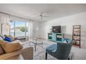 Bright living room with comfortable seating, a large TV, and a stylish coffee table at 2386 Sumatran Way # 34, Clearwater, FL 33763