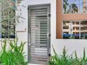 Modern gray metal gate with horizontal bars leading to the front entrance of the house at 3020 W Santiago St # 4, Tampa, FL 33629