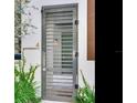 Modern gray metal gate with horizontal bars and a brass address number at 3020 W Santiago St # 4, Tampa, FL 33629