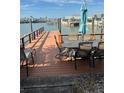 Wooden dock with patio furniture overlooking the water at 409 Boca Ciega Point S Blvd # 1008, St Petersburg, FL 33708