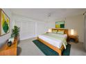 Bright bedroom with wooden bed, closet and green accents at 460 S Woodlands Dr, Oldsmar, FL 34677