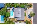 Aerial view showcasing a home's backyard pool and patio area at 490 82Nd Ave, St Pete Beach, FL 33706