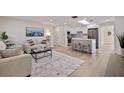 Open living room and kitchen with modern island and appliances at 490 82Nd Ave, St Pete Beach, FL 33706