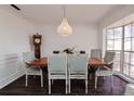 Elegant dining room with a rustic wooden table and statement light fixture at 5120 55Th N St, Kenneth City, FL 33709