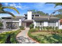 A well-maintained front yard leads to the entrance of this beautiful home at 9703 Stillwater Ct, Tampa, FL 33618