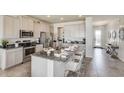 Modern kitchen featuring stainless steel appliances, granite countertops, and an island with seating at 10806 Patoka Ter, Parrish, FL 34219