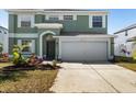 Charming two-story home featuring an attached two-car garage and attractive landscaping at 11351 Callaway Pond Dr, Riverview, FL 33579