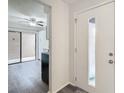 Bright entryway with view of kitchen and sliding glass door at 12914 Fairway Dr # A, Hudson, FL 34667